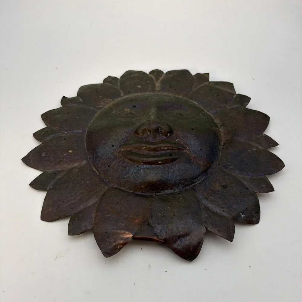 vintage sun wall plaque made of hammered copper sheet metal.